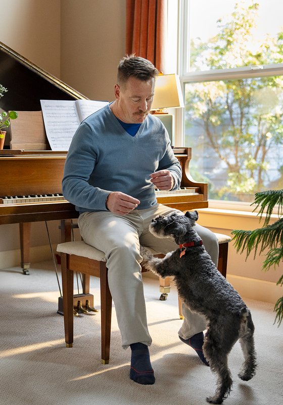 Andrew, a real AYVAKIT® (avapritinib) patient, playing with his dog
