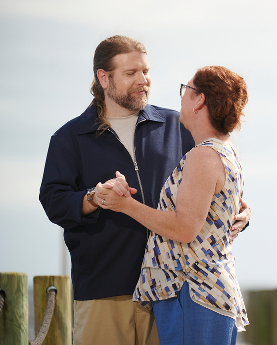 Pete, a real ISM patient, dances with a woman